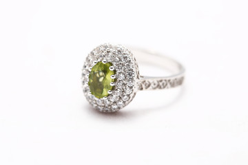green gem stone on diamond ring