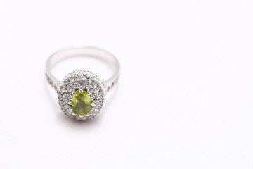 green gem stone on diamond ring