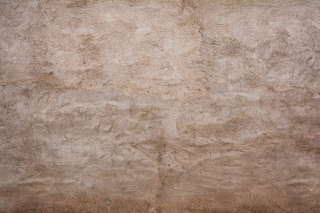 Unruhig verputzte Wand beige