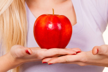 Woman hand holding red apple, healthy food concept