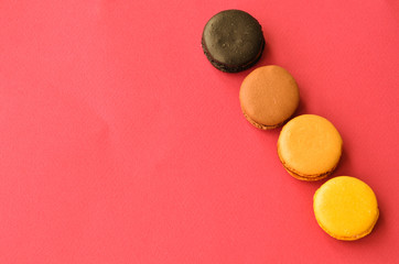 four macaroons on a pink background with a place under the text