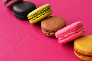 macaroons on a pink background with a place under the text