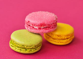 Fototapeta na wymiar macaroons on a pink background with a place under the text