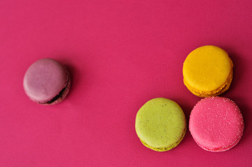 macaroons on a pink background with a place under the text