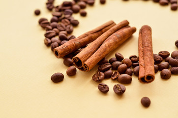 coffee beans in a circle with cinnamon on a yellow background with a place under the text