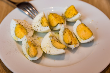 Boiled eggs with salt pepper and olive oil