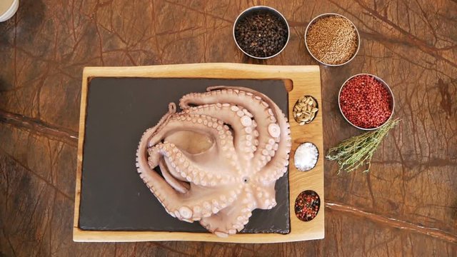 Fresh octopus is on cutting board in the restaurant