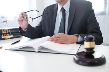 Legal counsel presents to the client a signed contract with gavel and legal law. justice and lawyer...