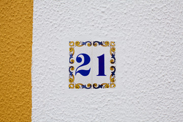 ceramics house number on the wall twenty one