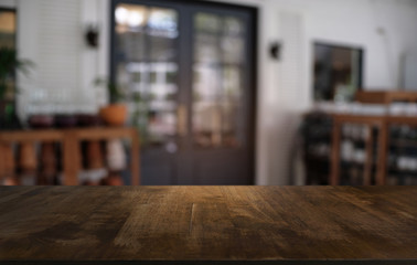 Empty dark wooden table in front of abstract blurred bokeh background of restaurant . can be used for display or montage your products.Mock up for space.