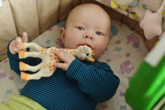 baby with teether toy