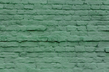 Exterior brick wall painted in green color