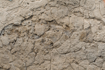 Old shabby exterior concrete wall with peeled off pieces