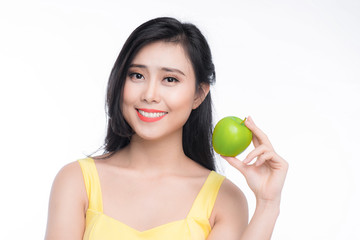 Pretty young asian woman holding fresh apple isolated on white background.