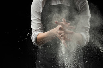 Obraz na płótnie Canvas handmade cotton chef with mold flour on a black background