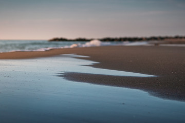 Beautiful ocean beach view with amazing sky and dunes reflection in the water. Lonstrup in North Jutland in Denmark, Skagerrak, North Sea