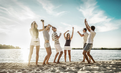 Happiness Friends funny dance on the beach under sunset sunlight