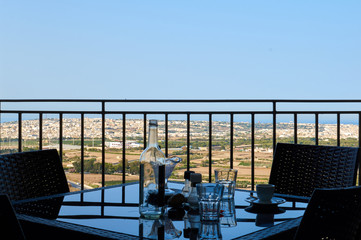 Cafe in medieval Mdina with Malta landscape behind