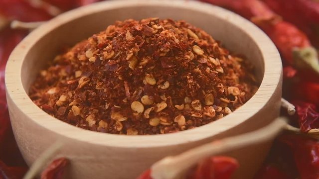 Chili powder in wood bowl rotation
