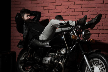 Fototapeta na wymiar motorcyclist. tired motorcyclist relax on bike. bearded motorcyclist on motorcycle. motorcyclist in leather jacket. real biker.
