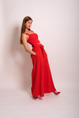 female Model Against white  Studio Background in red suit