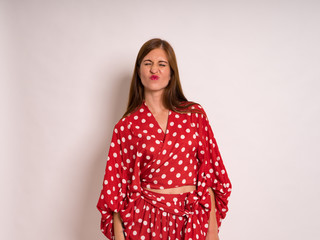 female Model Against white  Studio Background in red dress