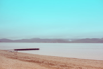 Fototapeta na wymiar Defocus Sea landscape hills horizon sky fog nature wooden pier .