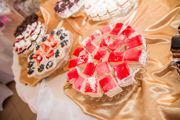Selection of cakes and pastry set up on cake stands for a party