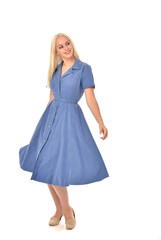 full length portrait of blonde girl wearing blue dress. standing pose. isolated on white  studio background.
