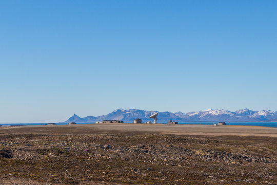 satellite dish in Ny Alesund, Svalbard, Spitsbergen, blue sky, mountains
