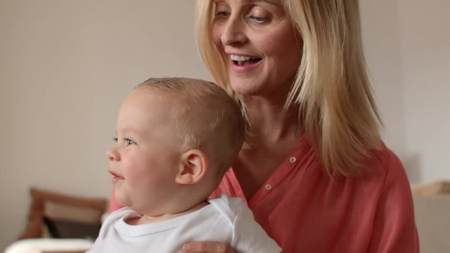 Grandmother and baby playing indoors