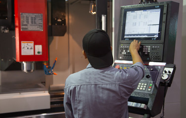 Industrial professional input data to program CNC vertical machining center machine. Industrial...