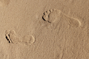 Fototapeta na wymiar two human footprints in the sand