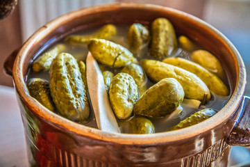 Brined pickles in a traditional clay pot