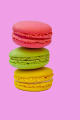 Tasty colorful macaroons on pink background