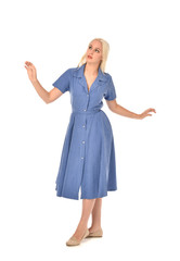 full length portrait of blonde girl wearing blue dress. standing pose. isolated on white  studio background.