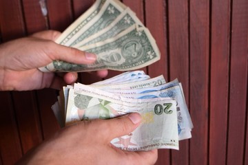 man hands dollar and Turkish lira