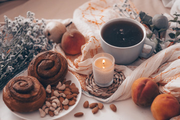 Breakfast in bed, a tray of tea, croissants, fruit, flowers. Morning. Cozy Apartment. Romance. bright Background layout. a day off