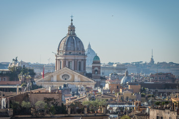 Fototapeta na wymiar The domes and rooftops of the eternal city, the view from the Spanish steps, Rome, Italy, sunny day and blue sky 