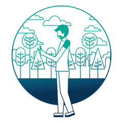 young man with smartphone in landscape