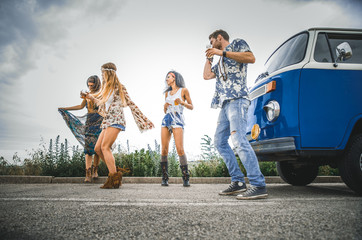 Obraz premium Happy friends driving a vintage minivan