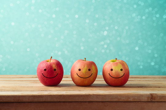 Jewish holiday Rosh Hashanah background with smiling apples