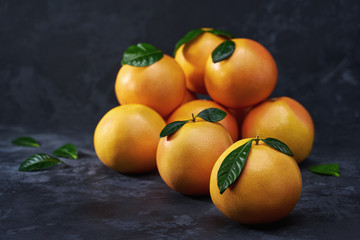 Ripe grapefruits  on a black background  .