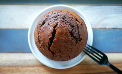 top view of round chocolate cake with wooden vintage background.