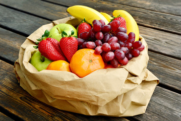 5 kind fresh  fruits in brown paper bag.
Mixed and colorful of fruits.