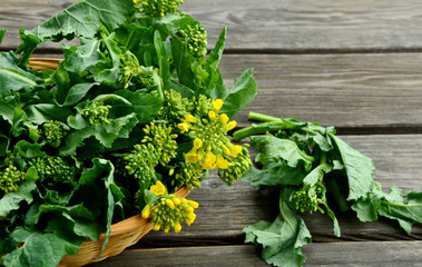 Fresh Rapeseed leaves and flowers in basket for cooking like a  broccoli and green vegetable.