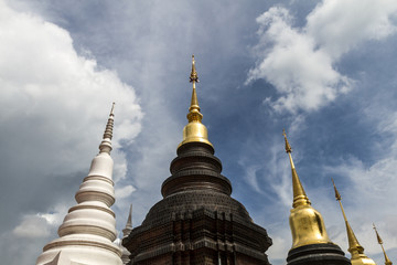 Fototapeta premium Low angle view of buddhist pagoda rising up into dramatic cloudy sky