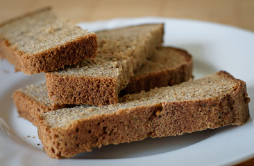 Fototapeta na wymiar Sliced rye bread on cutting board closeup
