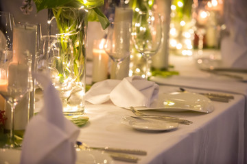 Wedding Banquet or gala dinner decorated with garlands. Festive Luxury table set up decor for wedding, party, event