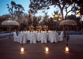 Wedding Banquet or gala dinner decorated with garlands. Festive Luxury table set up decor for wedding, party, event